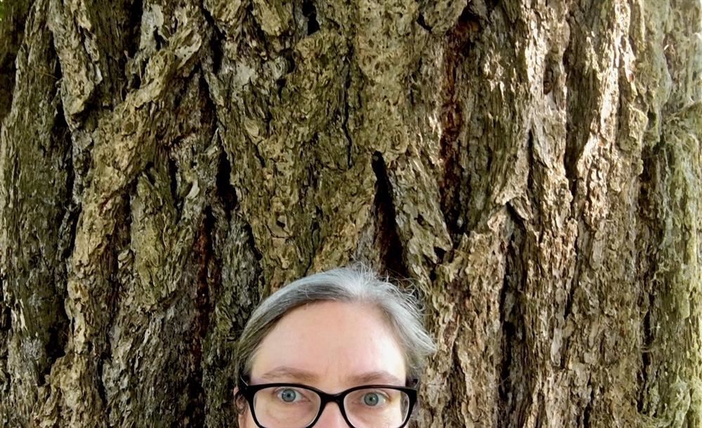 Ms. Mjelde in front of a Douglas Fir